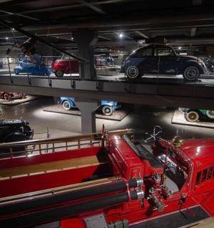 a red truck on display in a car museum