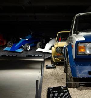 a group of cars on display in a garage