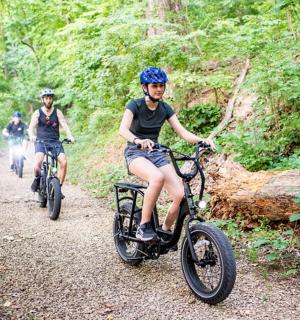 a group of people riding bikes down a trail