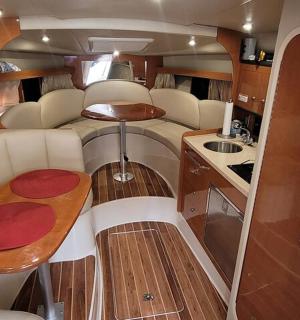 an interior of an rv with a table and a kitchen