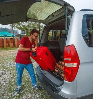 a man putting a surfboard into the back of a van