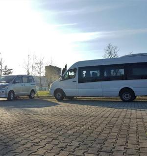 a white van and a white van parked in a parking lot