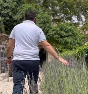 a man walking down a path in the grass