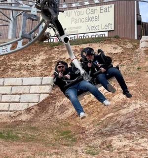 a group of people taking a picture in the dirt