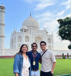 a man and a woman standing in front of a building