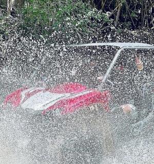 a man driving a golf cart in the water