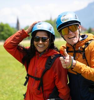 a man and woman wearing helmets posing for a picture