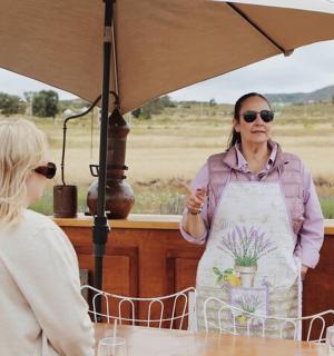 a woman in an apron standing under an umbrella