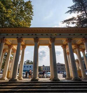 a building with columns and stairs in a city