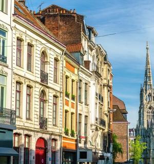 a group of buildings on a city street with a church