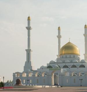 a mosque with a gold dome on top of it