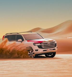 a white truck driving in the sand in the desert