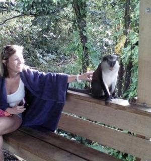 a woman sitting on a porch with a cat