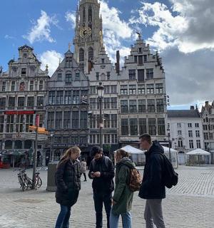 a group of people standing in front of a large building