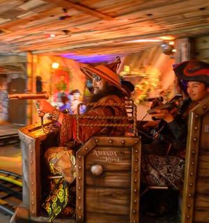 two people riding on a trolley in a carousel