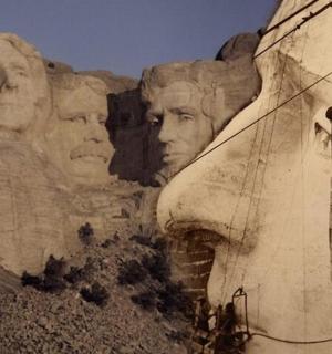 a painting of faces on the side of a wall