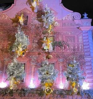 a pink building with christmas decorations on it