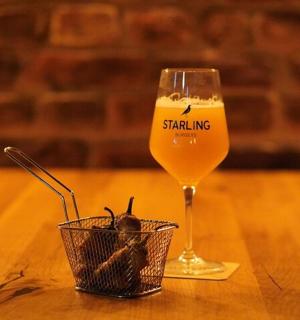 a glass of wine sitting on a wooden table with a basket
