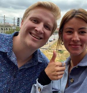 a man and a woman giving a thumbs up