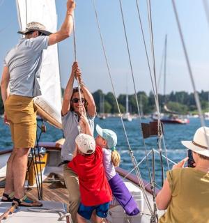 a group of people on a sail boat
