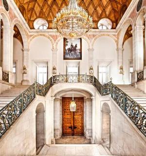 a large building with stairs and a chandelier