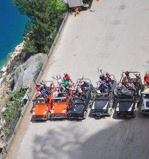 a group of people riding in the back of a four wheeler