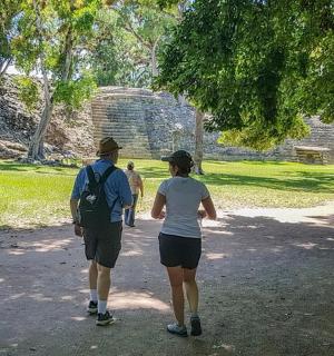 two people walking down a path in a park