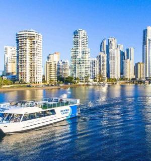 a boat on the water in front of a city