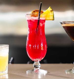 two cocktails sitting on a table next toermottermott