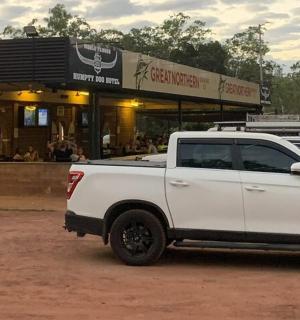 a white truck parked in front of a restaurant