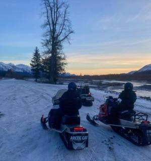 a group of people riding motorcycles in the snow