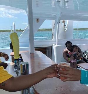 a group of people sitting around a table on a boat