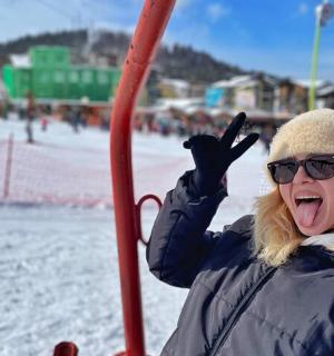 a woman with her hands up on a swing
