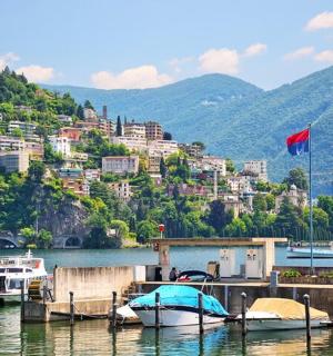 a group of boats docked at a dock on a lake
