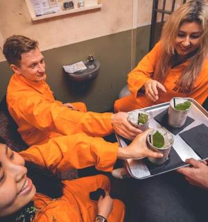a group of people sitting around a table with food