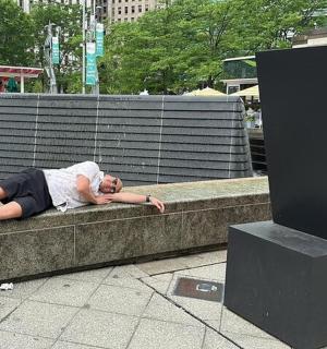 a woman laying on a ledge next to a wall