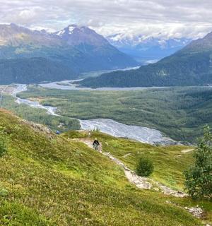 a view of a valley with a river and mountains