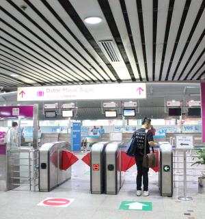 a woman is waiting for her luggage at an airport