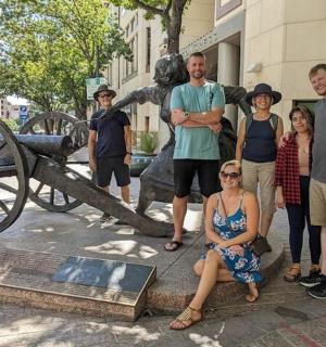 a group of people standing in front of a statue