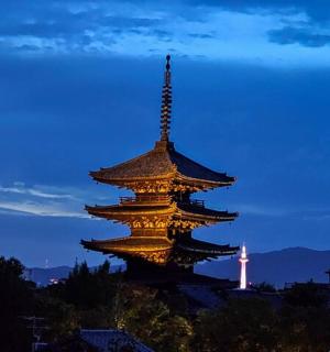 a large building with a lit up tower at night