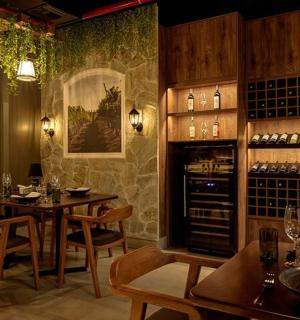 a restaurant with a table and chairs and wine bottles