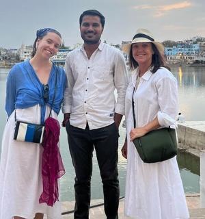 一名男子和两名女子站在水边