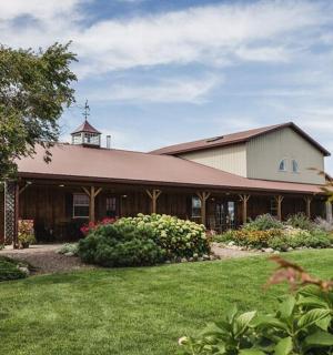 a large white building with a grass yard