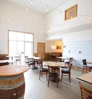 a dining room with tables and chairs and a large window