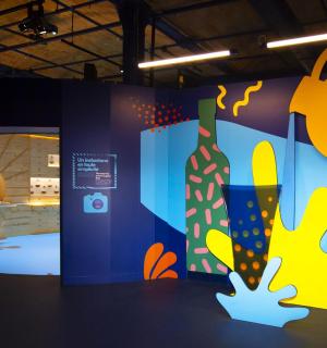 a room with a wall with a painting of a bottle