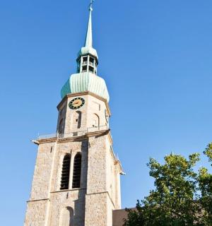 a tall tower with a clock on the top of it