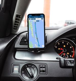 a cell phone sitting on the dashboard of a car
