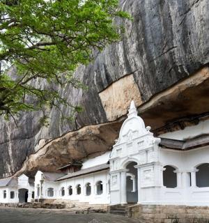 a white building in front of a mountain
