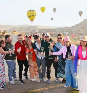 a group of people posing for a picture with wine glasses