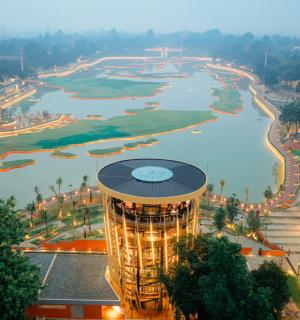 a view of a city with a river and a tower